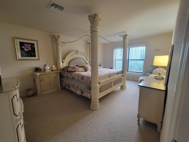 bedroom with light colored carpet, visible vents, and ornate columns