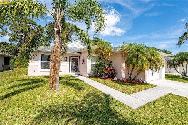 ranch-style home with a garage, stucco siding, concrete driveway, and a front lawn