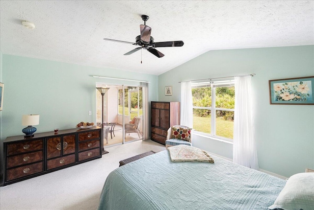 bedroom featuring access to exterior, a textured ceiling, carpet flooring, ceiling fan, and vaulted ceiling