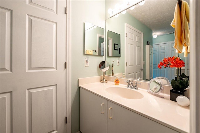 bathroom with a textured ceiling and vanity