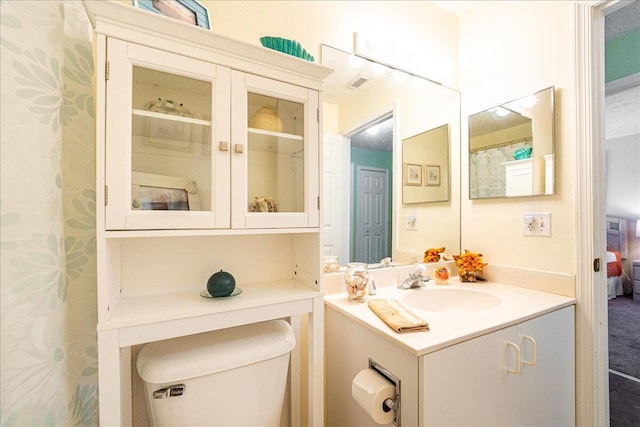 ensuite bathroom with vanity, toilet, visible vents, and ensuite bathroom