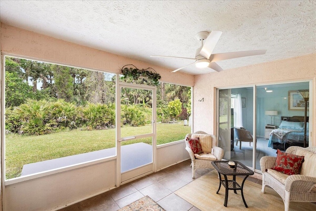 sunroom / solarium with a ceiling fan