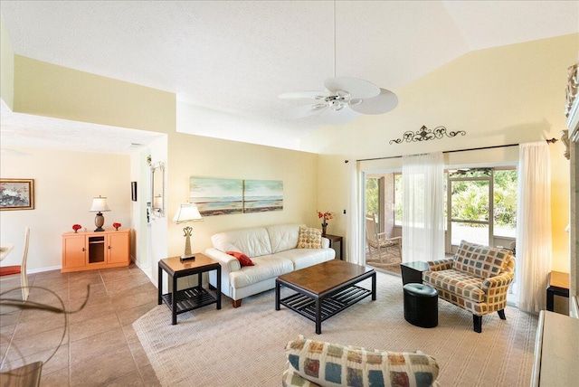 living room with light tile patterned flooring, baseboards, a ceiling fan, and vaulted ceiling