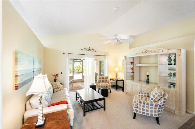 living area with a ceiling fan, lofted ceiling, and carpet floors