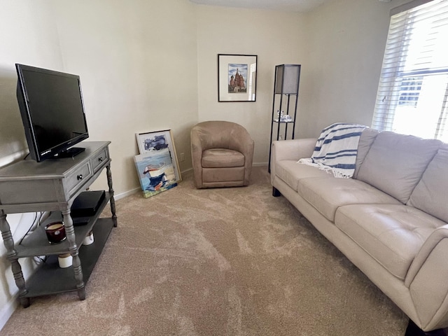 living room with baseboards and light carpet