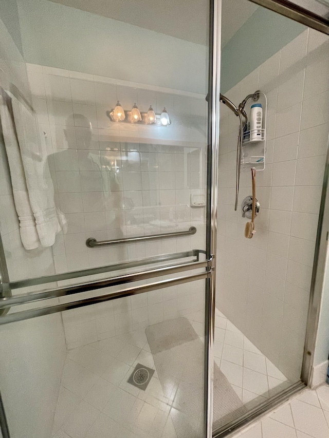 bathroom with tile patterned flooring and a stall shower