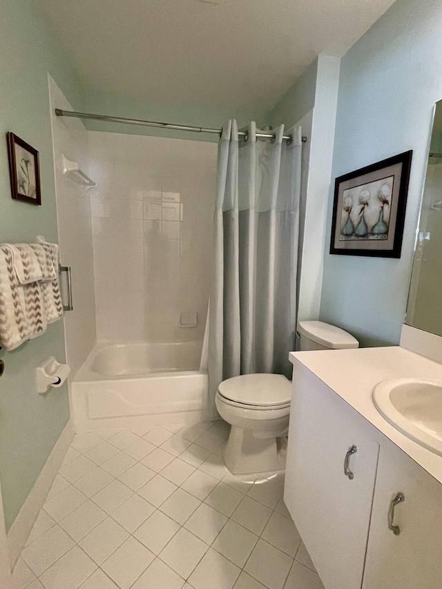 bathroom with tile patterned floors, shower / bath combination with curtain, toilet, and vanity