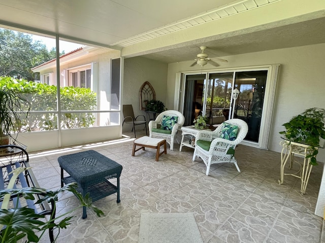 sunroom / solarium with beamed ceiling, a ceiling fan, and a wealth of natural light