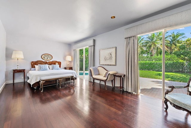 bedroom featuring access to exterior, dark wood-style floors, and baseboards