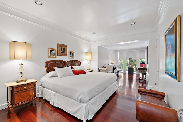 bedroom with dark wood finished floors, crown molding, recessed lighting, and baseboards