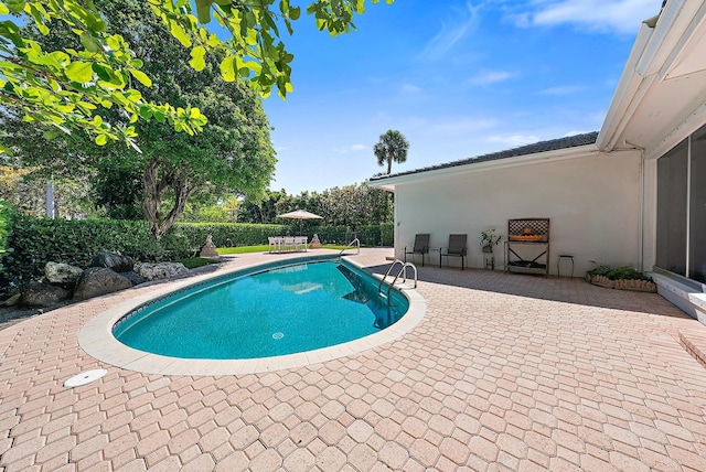 view of swimming pool featuring a fenced in pool and a patio