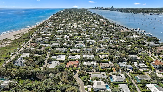 bird's eye view with a water view and a beach view