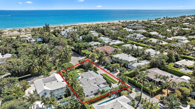 drone / aerial view with a beach view, a water view, and a residential view