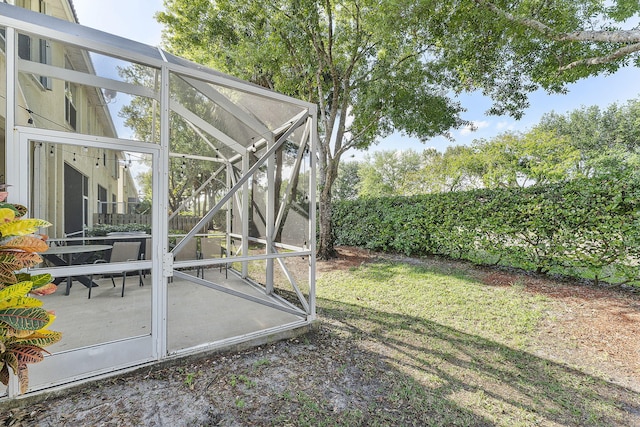 view of yard featuring glass enclosure