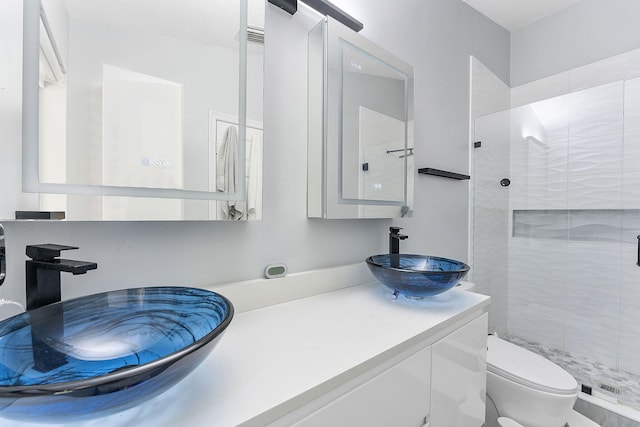 full bath with a shower stall, toilet, and vanity