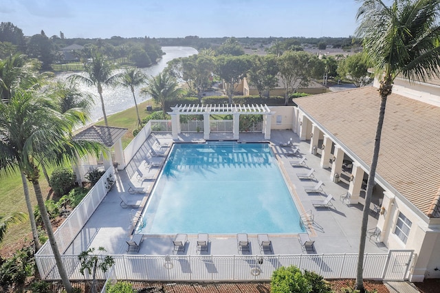 community pool featuring a patio, a pergola, and fence