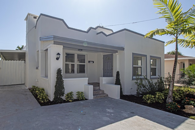 view of front of property with fence and stucco siding