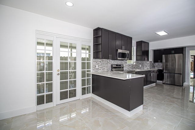 kitchen featuring open shelves, a sink, tasteful backsplash, stainless steel appliances, and light countertops