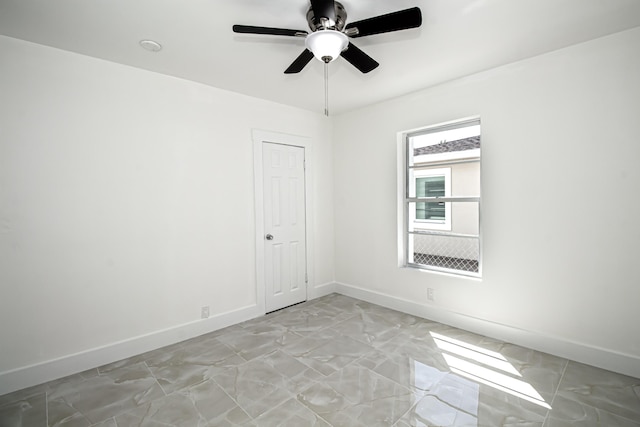 spare room featuring baseboards and ceiling fan