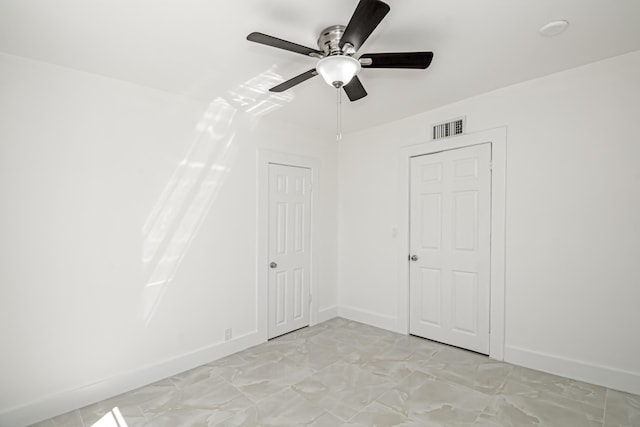 unfurnished room with visible vents, baseboards, and a ceiling fan