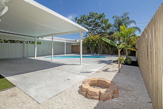 view of pool featuring a patio area, a fenced in pool, an outdoor fire pit, and a fenced backyard