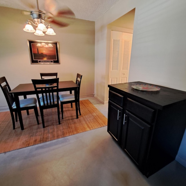 dining space with baseboards, a textured ceiling, and ceiling fan