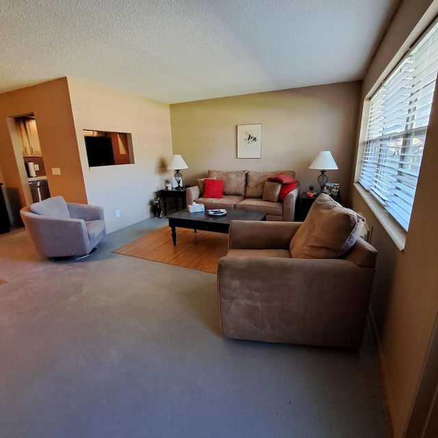 living area featuring a textured ceiling
