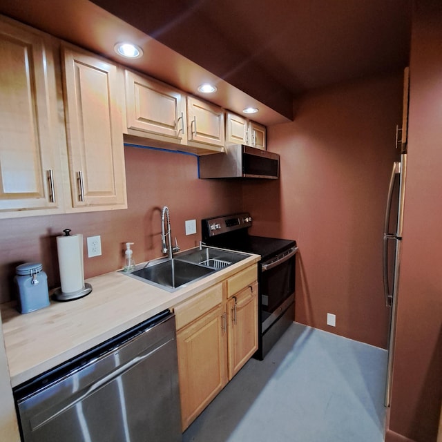 kitchen featuring recessed lighting, light brown cabinets, appliances with stainless steel finishes, and a sink
