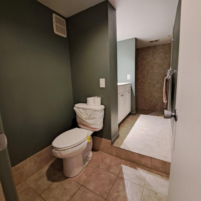 bathroom featuring tile patterned floors, visible vents, toilet, and vanity