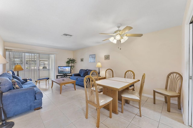 dining room featuring light tile patterned floors, baseboards, visible vents, and ceiling fan