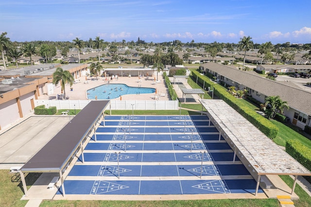 community pool featuring shuffleboard and fence