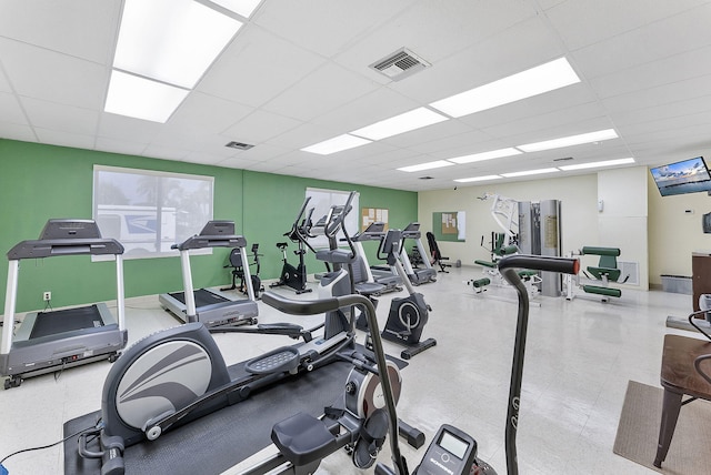 gym with visible vents and a paneled ceiling