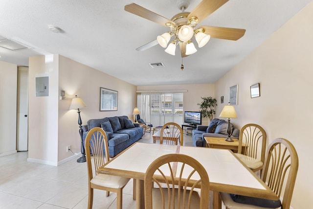 dining room with baseboards, visible vents, electric panel, light tile patterned flooring, and ceiling fan