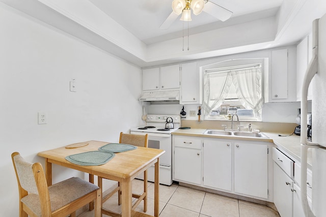 kitchen with under cabinet range hood, white appliances, white cabinetry, a ceiling fan, and a sink