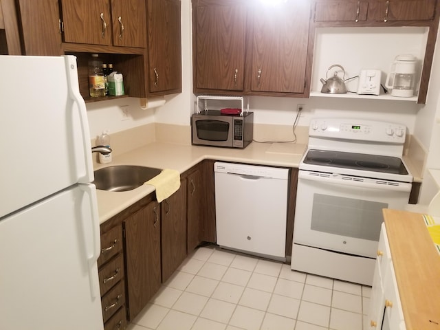 kitchen featuring white appliances, light tile patterned floors, open shelves, a sink, and light countertops