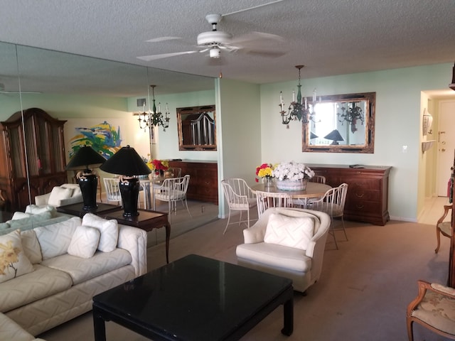 carpeted living area featuring ceiling fan with notable chandelier and a textured ceiling