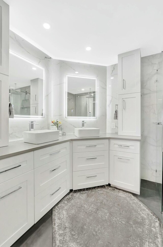 9238 E Vineland Ct E Unit E, Boca Raton, FL 33496 - bathroom featuring double vanity, recessed lighting, a marble finish shower, and a sink