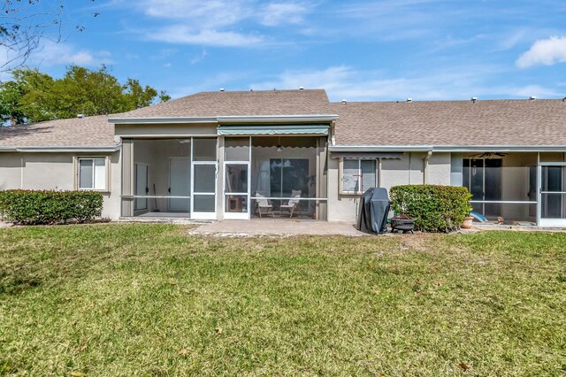 9238 E Vineland Ct E Unit E, Boca Raton, FL 33496 - rear view of property with a lawn, a sunroom, roof with shingles, and stucco siding