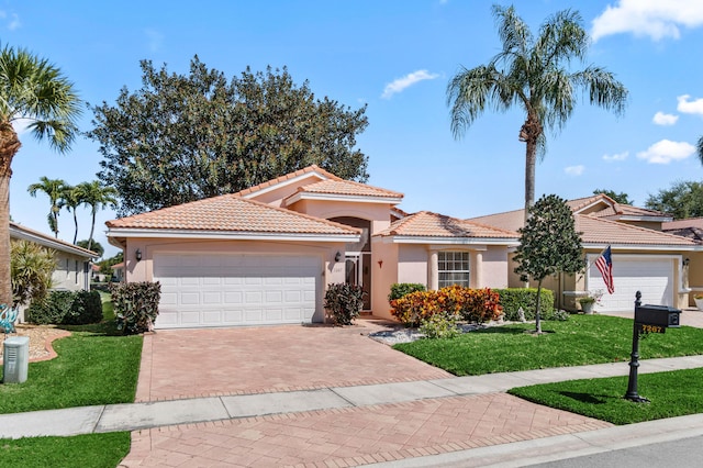 7267 Modena Dr, Boynton Beach, FL 33437 - mediterranean / spanish house with a front lawn, a tile roof, stucco siding, decorative driveway, and an attached garage