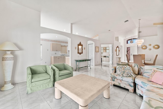 7267 Modena Dr, Boynton Beach, FL 33437 - living room with visible vents, an inviting chandelier, lofted ceiling, arched walkways, and marble finish floor