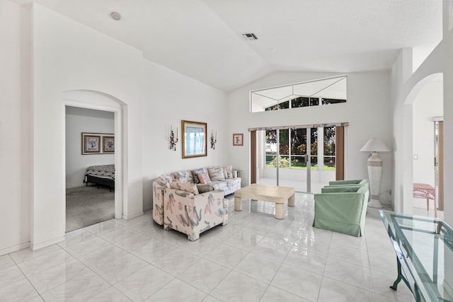 7267 Modena Dr, Boynton Beach, FL 33437 - living room with lofted ceiling, light tile patterned flooring, visible vents, and arched walkways