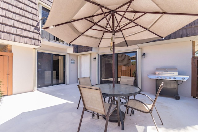 view of patio with a grill and outdoor dining space