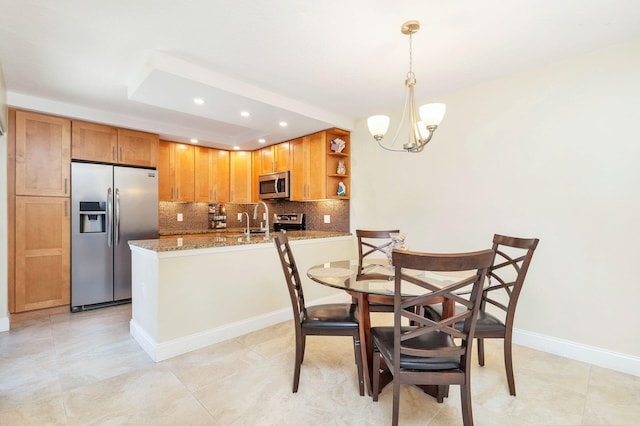 dining space featuring a tray ceiling, recessed lighting, light tile patterned floors, baseboards, and a chandelier