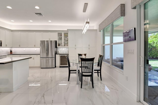 7855 Wildflower Shores Dr, Delray Beach, FL 33446 - dining area featuring beverage cooler, visible vents, marble finish floor, and recessed lighting