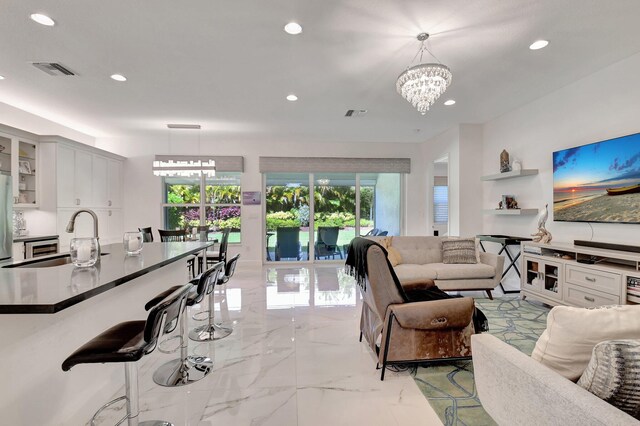 7855 Wildflower Shores Dr, Delray Beach, FL 33446 - living area with a notable chandelier, visible vents, recessed lighting, and marble finish floor