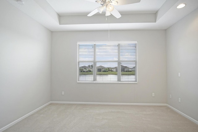 11243 SW Parkside Dr, Port Saint Lucie, FL 34987 - spare room featuring ceiling fan, light colored carpet, and a tray ceiling