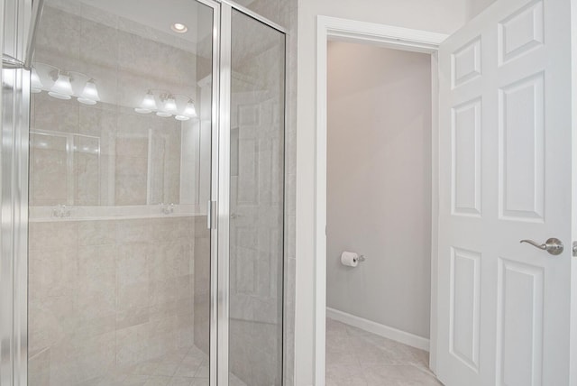 full bathroom featuring tile patterned floors, a shower stall, and baseboards