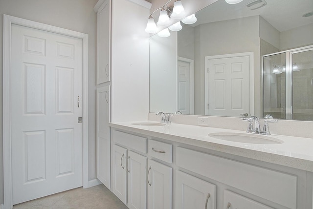 11243 SW Parkside Dr, Port Saint Lucie, FL 34987 - full bathroom featuring tile patterned floors, a stall shower, double vanity, and a sink