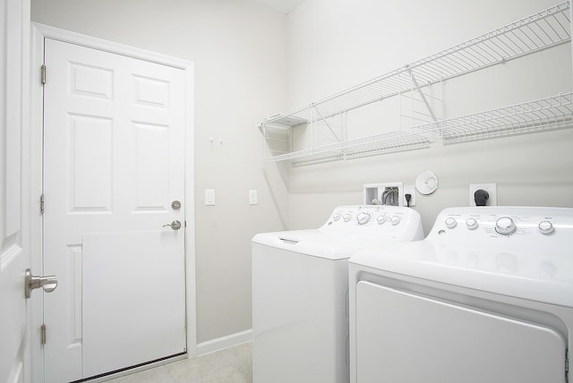 laundry room with washer and clothes dryer, laundry area, and baseboards