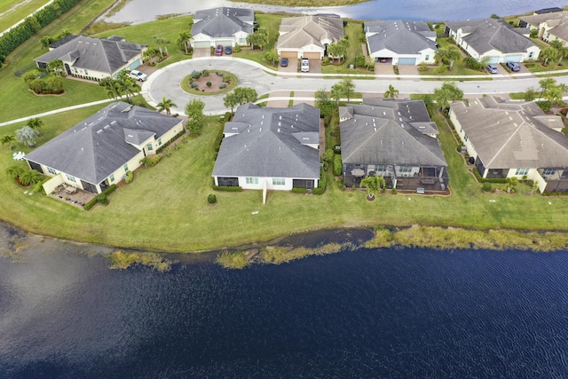 birds eye view of property featuring a residential view and a water view